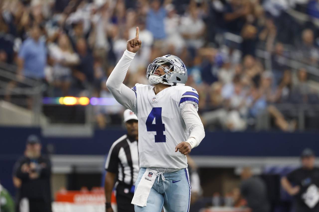 Dallas Cowboys quarterback Dak Prescott (4) celebrates after throwing a touchdown pass to tight end...