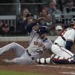 
              Houston Astros' Kyle Tucker scores past Atlanta Braves catcher Travis d'Arnaud on a single by Martin Maldonado during the seventh inning in Game 5 of baseball's World Series between the Houston Astros and the Atlanta Braves Sunday, Oct. 31, 2021, in Atlanta. (AP Photo/Brynn Anderson)
            