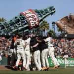 
              The San Francisco Giants celebrate after defeating the San Diego Padres in a baseball game in San Francisco, Sunday, Oct. 3, 2021. (AP Photo/John Hefti)
            