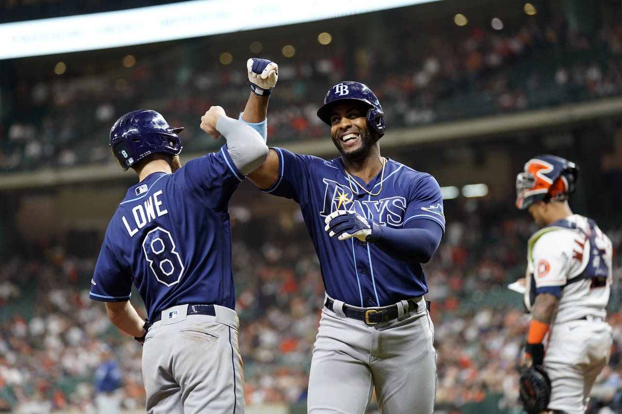 Tampa Bay Rays' Yandy Diaz, right, celebrates with Brandon Lowe (8) after both scored on Diaz's hom...