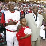 
              FILE - In this June 20, 2009, file photo, Cincinnati Reds manager Dusty Baker, left, stands with his son Darren Baker, center, and baseball great Hank Aaron as the national anthem is played at the Civil Rights Game ceremony before a game between the Chicago White Sox and the Cincinnati Reds in Cincinnati. Baker, now the manager of the Houston Astros, and Brian Snitker, manager of the Atlanta Braves, say Aaron would have loved being able to watch this World Series. (AP Photo/David Kohl, File)
            