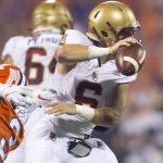 
              Boston College quarterback Dennis Grosel (6) avoids a tackle by Clemson defensive end Xavier Thomas (3) during the first half of an NCAA college football game, Saturday, Oct. 2, 2021, in Clemson, S.C. (AP Photo/Hakim Wright Sr.)
            