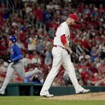
              St. Louis Cardinals relief pitcher T.J. McFarland, right, walks back to the mound after giving up a three-run home run to Chicago Cubs' Trayce Thompson, left, during the sixth inning of a baseball game Friday, Oct. 1, 2021, in St. Louis. (AP Photo/Jeff Roberson)
            