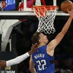 
              Orlando Magic's Franz Wagner (22) scores a basket while defended by New York Knicks' RJ Barrett during an NBA basketball game Sunday, Oct. 24, 2021, in New York. (AP Photo/John Munson)
            