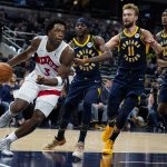 
              Toronto Raptors forward OG Anunoby (3) drives past Indiana Pacers forwards Justin Holiday (8) and Domantas Sabonis (11) during the first half of an NBA basketball game in Indianapolis, Saturday, Oct. 30, 2021. (AP Photo/Michael Conroy)
            