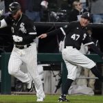 
              Chicago White Sox's Yoan Moncada, left, celebrates with third base coach Joe McEwing after hitting a two-run home run during the eighth inning of a baseball game against the Detroit Tigers in Chicago, Saturday, Oct. 2, 2021. (AP Photo/Nam Y. Huh)
            