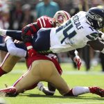 
              Seattle Seahawks wide receiver DK Metcalf (14) scores against San Francisco 49ers linebacker Azeez Al-Shaair, rear, and cornerback Jimmie Ward during the first half of an NFL football game in Santa Clara, Calif., Sunday, Oct. 3, 2021. (AP Photo/Jed Jacobsohn)
            