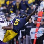 
              Michigan wide receiver Mike Sainristil (5), defended by Northwestern defensive back Rod Heard II (24) stretches but is unable to catch the pass during the second half of an NCAA college football game, Saturday, Oct. 23, 2021, in Ann Arbor, Mich. (AP Photo/Carlos Osorio)
            