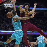 
              Charlotte Hornets' Cody Martin, left, dunks against Cleveland Cavaliers' Jarrett Allen during the second half of an NBA basketball game Friday, Oct. 22, 2021, in Cleveland. Charlotte won 123-112. (AP Photo/Tony Dejak)
            