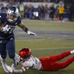 
              Nevada running back Toa Taua (35) is tackled by UNLV's Cameron Oliver (25) during the first half of an NCAA college football game in Reno, Nev., Friday, Oct. 29, 2021. (AP Photo/Tom R. Smedes)
            