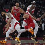 
              Toronto Raptors guard Fred VanVleet (23) drives the ball past Chicago Bulls guard Zach LaVine (8) during first-half NBA basketball game action in Toronto, Monday, Oct. 25, 2021. (Nathan Denette/The Canadian Press via AP)
            