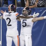 
              Virginia quarterback Brennan Armstrong (5) and wide receiver Ra'Shaun Henry (2) celebrate a touchdown during the first half of the team's NCAA college football game against BYU on Saturday, Oct. 30, 2021, in Provo, Utah. (AP Photo/George Frey)
            