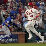 
              St. Louis Cardinals' Harrison Bader (48) scores past Chicago Cubs catcher Erick Castillo during the seventh inning of a baseball game Saturday, Oct. 2, 2021, in St. Louis. (AP Photo/Jeff Roberson)
            