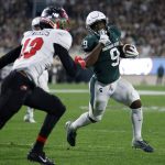 
              Michigan State's Kenneth Walker III, right, runs for a touchdown against Western Kentucky's Miguel Edwards during the first quarter of an NCAA college football game, Saturday, Oct. 2, 2021, in East Lansing, Mich. (AP Photo/Al Goldis)
            