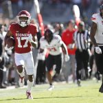 
              Oklahoma wide receiver Marvin Mims (17) runs ahead of Texas Tech defensive back Malik Dunlap (8) for a touchdown during the first half an NCAA college football game, Saturday, Oct. 30, 2021, in Norman, Okla. (AP Photo/Alonzo Adams)
            