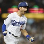 
              Los Angeles Dodgers' Trea Turner reacts as he runs the bases after hitting a grand slam home run during the fifth inning of a baseball game against the Milwaukee Brewers Friday, Sept. 1, 2021, in Los Angeles. Austin Barnes, Albert Pujols, and Mookie Betts also scored. (AP Photo/Ashley Landis)
            