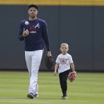 
              Atlanta Braves' Freddie Freeman walks with his son, Charlie, uring a workout ahead of the NLCS playoff baseball game, Thursday, Oct. 14, 2021, in Atlanta. (AP Photo/Brynn Anderson)
            