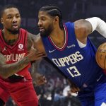 
              Los Angeles Clippers guard Paul George, right, is defended by Portland Trail Blazers guard Damian Lillard during the first half of an NBA basketball game Monday, Oct. 25, 2021, in Los Angeles. (AP Photo/Marcio Jose Sanchez)
            