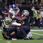 
              New Orleans Saints cornerback Paulson Adebo (29) and free safety Marcus Williams try to tackle New York Giants wide receiver John Ross (12) on a touchdown reception in the first half of an NFL football game in New Orleans, Sunday, Oct. 3, 2021. (AP Photo/Derick Hingle)
            