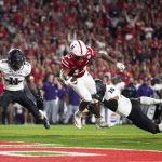 
              Nebraska's Rahmir Johnson (14) dives into the end zone to score a touchdown ahead of Northwestern's A.J. Hampton (11) and Zac Krause (16) during the first half of an NCAA college football game Saturday, Oct. 2, 2021, at Memorial Stadium in Lincoln, Neb. (AP Photo/Rebecca S. Gratz)
            