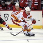 
              Calgary Flames center Tyler Pitlick (18) chases after the puck during the second period of an NHL hockey game against the New Jersey Devils Tuesday, Oct. 26, 2021, in Newark, N.J. (AP Photo/Bill Kostroun)
            