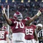 
              Alabama offensive lineman Javion Cohen (70) signals a touchdown after a dive into the end zone by quarterback Bryce Young during the second half of an NCAA college football game against Tennessee, Saturday, Oct. 23, 2021, in Tuscaloosa, Ala. (AP Photo/Vasha Hunt)
            