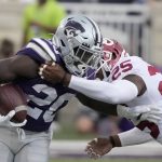
              Kansas State running back Joe Ervin (20) is tackled by Oklahoma defensive back Justin Broiles (25) during the first half of an NCAA college football game in Manhattan, Kan., Saturday, Oct. 2 2021. (AP Photo/Orlin Wagner)
            