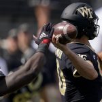 
              Wake Forest quarterback Sam Hartman passes under pressure by Louisville during the first half of an NCAA college football game on Saturday, Oct. 2, 2021, in Winston-Salem, N.C. (AP Photo/Chris Carlson)
            