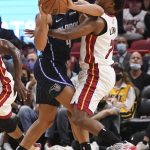 
              Miami Heat guard Kyle Lowry (7) defends Orlando Magic guard Jalen Suggs (4) during the first half of an NBA basketball game, Monday, Oct. 25, 2021, in Miami. (AP Photo/Marta Lavandier)
            