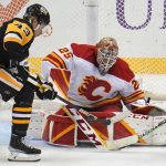 
              Calgary Flames goaltender Jacob Markstrom (25) blocks a shot by Pittsburgh Penguins' Danton Heinen (43) during the third period of an NHL hockey game in Pittsburgh, Thursday, Oct. 28, 2021. (AP Photo/Gene J. Puskar)
            
