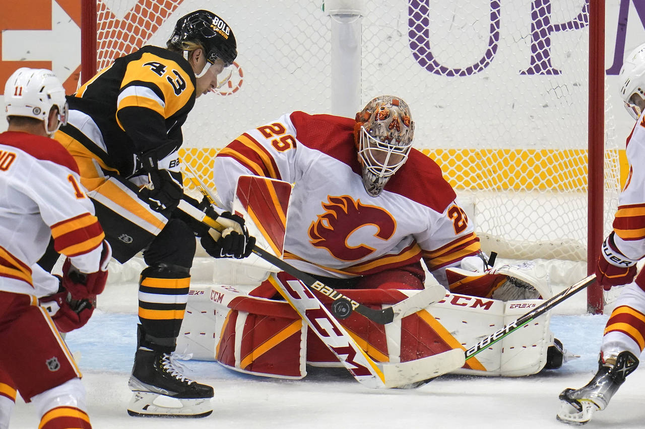 Calgary Flames goaltender Jacob Markstrom (25) blocks a shot by Pittsburgh Penguins' Danton Heinen ...
