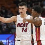 
              Miami Heat guards Tyler Herro (14) and Kyle Lowry (7) gesture on the court during the first half of an NBA basketball game, Monday, Oct. 25, 2021, in Miami. (AP Photo/Marta Lavandier)
            