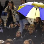
              East Carolina fans dance in the rain during an NCAA college football game against South Florida, Thursday, Oct. 28, 2021, in Greenville, N.C. (Scott Davis/The Daily Reflector via AP)
            