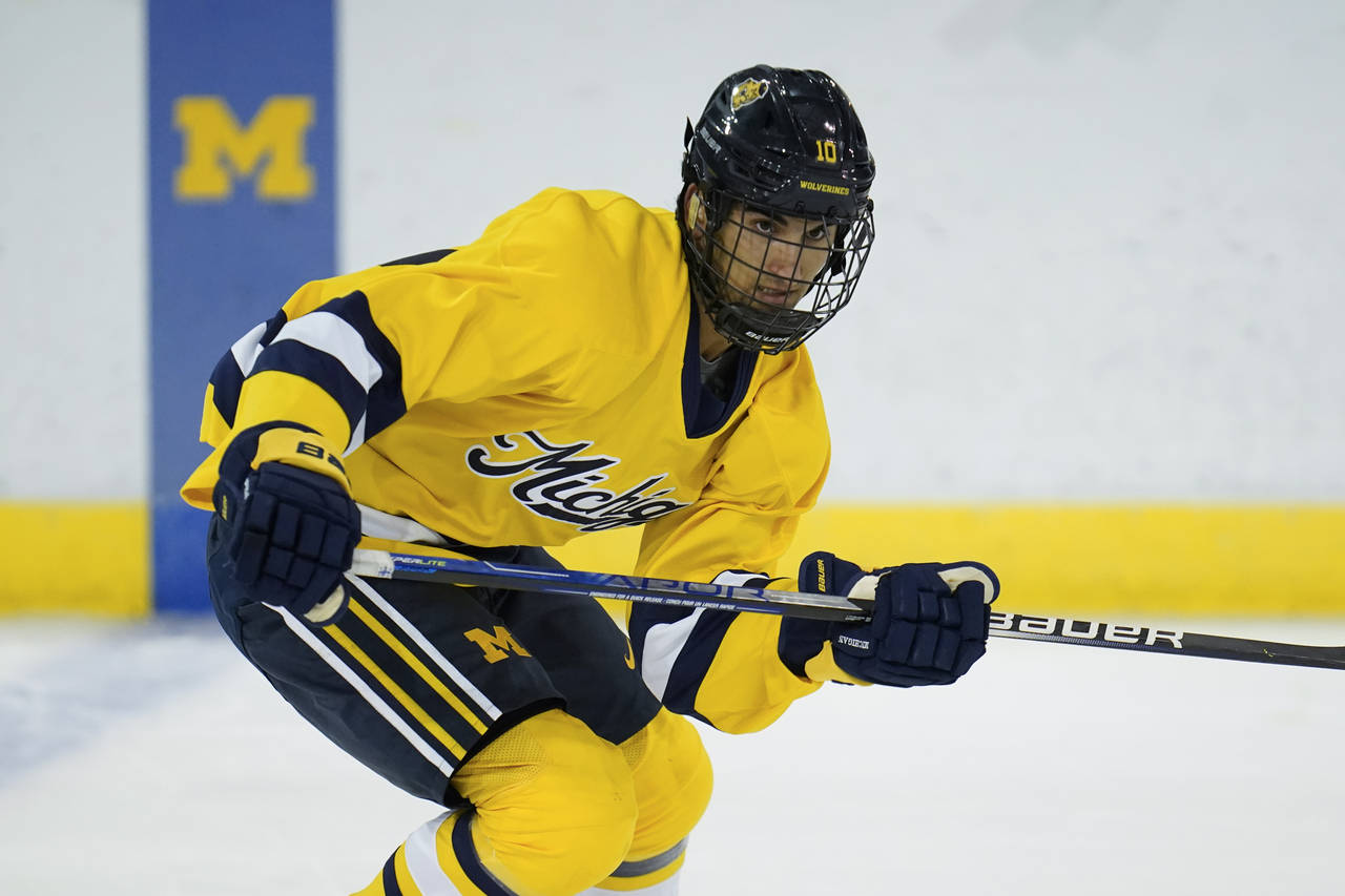 University of Michigan center Matty Beniers (10) skates during an NCAA college hockey practice in A...
