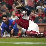 
              Chicago Cubs' Willson Contreras, left, loses his helmet after being tagged out at the plate by St. Louis Cardinals catcher Andrew Knizner during the ninth inning of a baseball game Friday, Oct. 1, 2021, in St. Louis. (AP Photo/Jeff Roberson)
            