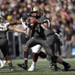 
              Army quarterback Christian Anderson (4) looks to pass under pressure against Wake Forest during the first half of an NCAA college football game Saturday, Oct. 23, 2021, in West Point, N.Y. (AP Photo/Adam Hunger)
            
