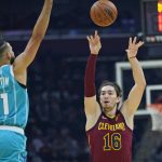 
              Cleveland Cavaliers' Cedi Osman (16) passes against Charlotte Hornets' Cody Martin (11) in the first half of an NBA basketball game, Friday, Oct. 22, 2021, in Cleveland. (AP Photo/Tony Dejak)
            