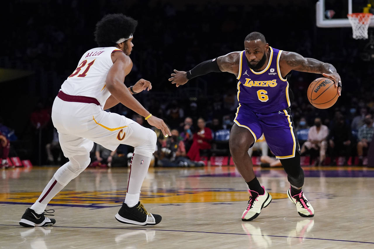 Los Angeles Lakers' LeBron James, right, drives around Cleveland Cavaliers' Jarrett Allen during th...