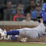 
              New York Mets' Francisco Lindor slides to score against the Atlanta Braves in the fourth inning of a baseball game Friday, Oct. 1, 2021, in Atlanta. Lindor scored on a triple by Mets' Pete Alonso. (AP Photo/Ben Margot)
            