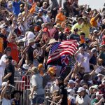 
              Spectators cheer at the start of the Formula One U.S. Grand Prix auto race at the Circuit of the Americas, Sunday, Oct. 24, 2021, in Austin, Texas. (AP Photo/Eric Gay)
            