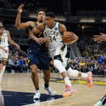 
              Milwaukee Bucks forward Giannis Antetokounmpo (34) drives past Indiana Pacers guard Malcolm Brogdon (7) during the second half of an NBA basketball game in Indianapolis, Monday, Oct. 25, 2021. The Bucks defeated the Pacers 119-109. (AP Photo/Michael Conroy)
            