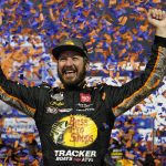 
              FILE - In this Sept. 11, 2021, file photo, Martin Truex Jr., celebrates winning the NASCAR Cup series auto race in Richmond, Va. Truex is in third place in the NASCAR playoff standings heading into Sunday's race at Fort Worth, Texas.  (AP Photo/Steve Helber, File)
            
