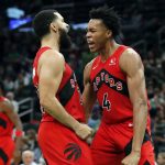 
              Toronto Raptors' Scottie Barnes (4) reacts with teammate Fred VanVleet after scoring during the second half of an NBA basketball game against the Boston Celtics, Friday, Oct. 22, 2021, in Boston. (AP Photo/Michael Dwyer)
            