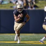 
              Navy quarterback Tai Lavatai runs with the ball against UCF during the first half of an NCAA college football game, Saturday, Oct. 2, 2021, in Annapolis, Md. (AP Photo/Julio Cortez)
            