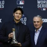 
              Shohei Ohtani holds the Commissioner's Historic Achievement Award from Rob Manfred before Game 1 in baseball's World Series between the Houston Astros and the Atlanta Braves Tuesday, Oct. 26, 2021, in Houston. (AP Photo/Ashley Landis)
            