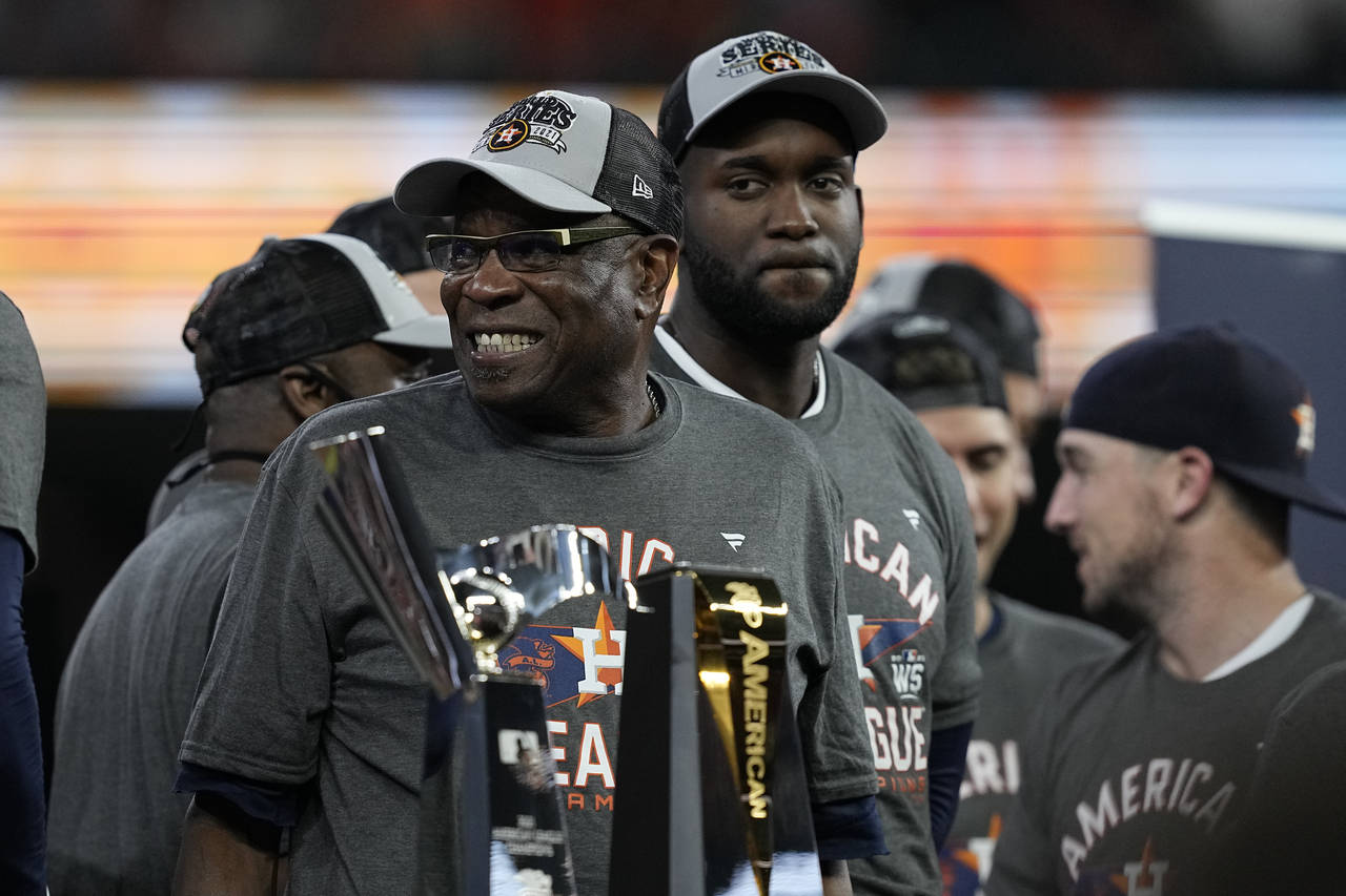 Houston Astros manager Dusty Baker Jr. stands by the trophy after their win against the Boston Red ...