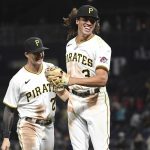 
              Pittsburgh Pirates' Cole Tucker (3) reacts with Kevin Newman (27) after a double play in the seventh inning against the Cincinnati Reds during a baseball game in Pittsburgh, Friday, Oct. 1, 2021. (AP Photo/Philip G. Pavely)
            
