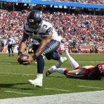 
              Seattle Seahawks quarterback Russell Wilson (3) runs for a touchdown past San Francisco 49ers defensive tackle Javon Kinlaw (99) during the second half of an NFL football game in Santa Clara, Calif., Sunday, Oct. 3, 2021. (AP Photo/Tony Avelar)
            