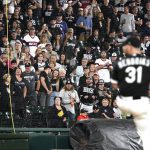 
              Fans stand as they watch Chicago White Sox relief pitcher Liam Hendriks work during the ninth inning of a baseball game against the Detroit Tigers in Chicago, Saturday, Oct. 2, 2021. (AP Photo/Nam Y. Huh)
            