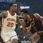 
              Cleveland Cavaliers' Evan Mobley (4) drives against Atlanta Hawks' John Collins (20) in the first half of an NBA basketball game, Saturday, Oct. 23, 2021, in Cleveland. (AP Photo/Tony Dejak)
            